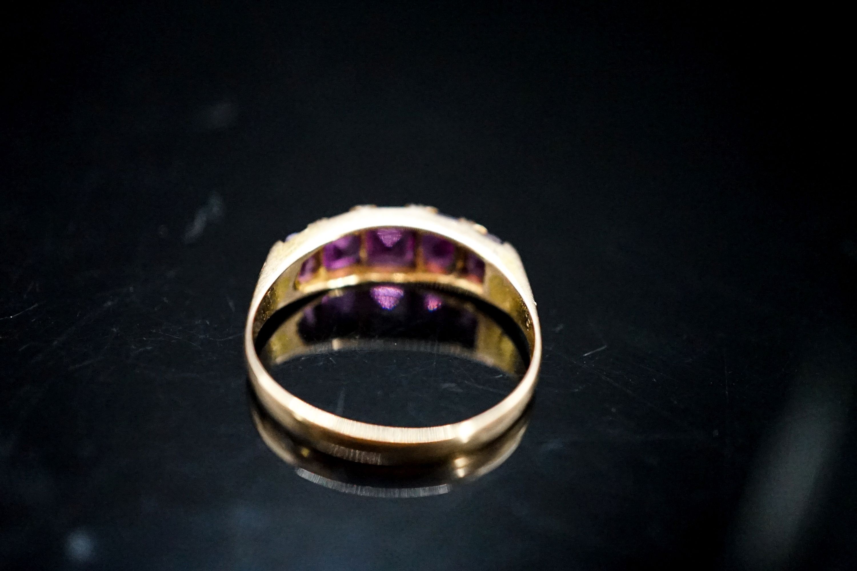 A Victorian 15ct gold and graduated five stone amethyst paste set half hoop ring, size O/P, gross 2.4 grams.